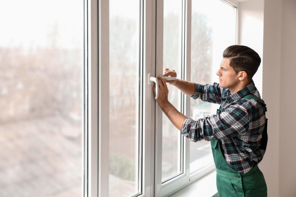 SWO Contracting man installing a new window and demonstrating maintenance practices. signs you need new windows