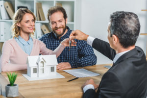 Tristan Squire Smith - happy couple receiving house keys celebrating homeownership - Real estate appraisal